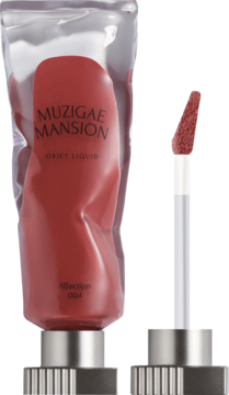 Muzigae Mansion Objet Liquid tint Affection 004, koralowa czerwień w zgniecionej tubce, obok srebrna nakrętka.