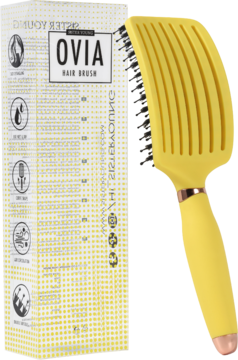Żółta wentylowana szczotka Ovia Hair Brush z włosiem dzika, częściowo wysunięta z żółtego pudełka, widok z przodu.
