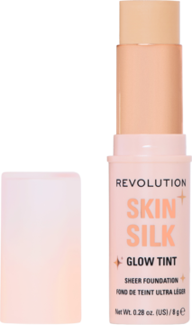 REVOLUTION SKIN SILK GLOW TINT, rozświetlający podkład w sztyfcie, w jasnym beżu, z otwartą zakrętką.