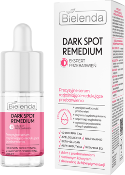 Różowe serum Bielenda Dark Spot Remedium z witaminą B12 w butelce z pipetą i białym kartoniku, widok z przodu.