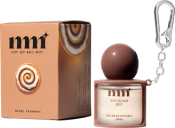Mgiełka mmm Milky Cinnamon do ciała i włosów w brązowej butelce z brelokiem, obok pudełko, widok z przodu.