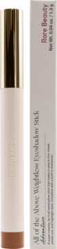 Rare Beauty Weightless Eyeshadow Stick, shade Adventure, beige with copper end and gold cap, next to its white box.