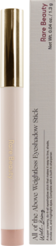 Rare Beauty 'Well-Being' Weightless Eyeshadow Stick, peach with gold cap, next to its light grey packaging box.