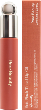 Rare Beauty Soft Pinch Tinted Lip Oil in Honesty, coral-red tube with silver cap, next to its matching retail box.