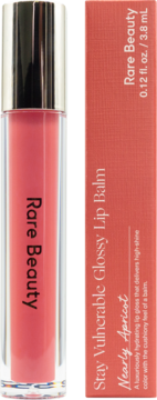 Rare Beauty Stay Vulnerable Glossy Lip Balm, Nearly Apricot in clear tube & coral box, upright.
