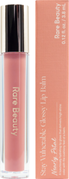 Rare Beauty Stay Vulnerable Glossy Lip Balm, Nearly Petal, soft petal-pink tint in clear tube with gold cap. Retail box shown. Frontal view, hydrating finish.