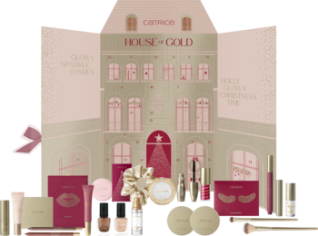 Otwarty kalendarz adwentowy Catrice HOUSE OF GOLD w kształcie domku, z lśniącymi kosmetykami do makijażu na ciemnym tle.