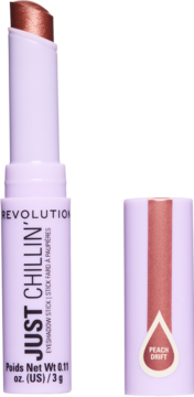Otwarty Revolution Just Chillin' Eyeshadow Stick Peach Drift, miedziany, w lawendowym opakowaniu, z boku nakrętka.
