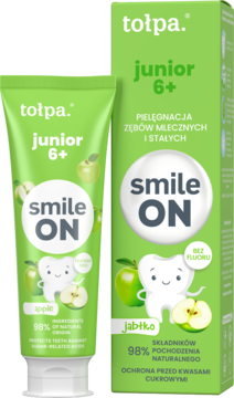Zielona pasta Tołpa Junior 6+ jabłkowa, bez fluoru, dla dzieci, w tubce i pudełku z rysunkiem zęba i jabłek.