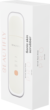 Białe pudełko na peeling kawitacyjny Beautifly Scrub Aqua Glow PRO, z widocznym białym urządzeniem i brzoskwiniowym przyciskiem, pod kątem.