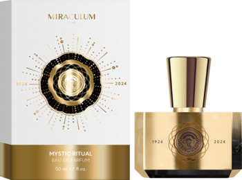 Złoty flakon i białe pudełko Mystic Ritual Eau de Parfum z promienistym, czarno-złotym wzorem na jasnym tle.
