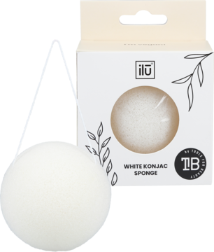 Biała gąbka konjac ilū do mycia twarzy obok kremowego opakowania. Na pudełku napis "WHITE KONJAC SPONGE".