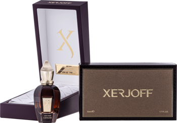 Zestaw perfum Xerjoff Ceylon: ciemna butelka, otwarta fioletowa szkatułka z logo X, obok brązowe pudełko.