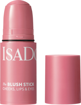Kremowy róż IsaDora The Blush Stick Rose Perfect, otwarty, z odłożoną nakrętką, na jasnoróżowym tle.