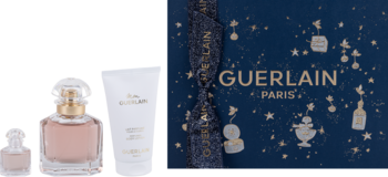 Zestaw Guerlain Mon Guerlain: perfumy, miniatura, balsam do ciała oraz granatowe pudełko ze złotym logo i gwiazdami.