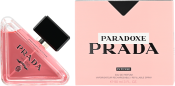 Prada Paradoxe damska woda perfumowana: różowy trójkątny flakon z czarną nakrętką i jasnoróżowe pudełko.