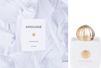 Biała butelka Amouage Honour Woman EDP z złotą nakrętką obok opakowania na pofałdowanej białej tkaninie.