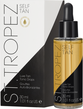 St.Tropez Self Tan Luxe Tan Tonic Drops: bursztynowy płyn w butelce z pipetą i biało-czarne opakowanie kartonowe.
