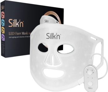Biała maska LED Silk'n Facial Mask 100 z diodami i kontrolerem, obok czarne opakowanie produktu.