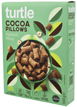 Ekologiczne Turtle Cocoa Pillows z nadzieniem orzechowym w zielonym pudełku, z miską płatków, widok z przodu.