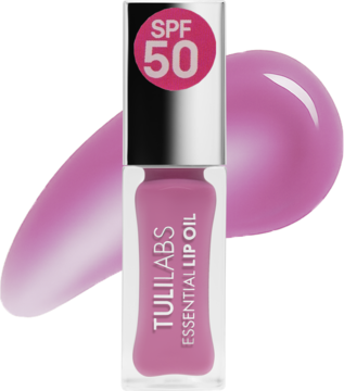 Różowy olejek Tuli Labs Essential z SPF 50 w przezroczystej butelce. Widoczne błyszczące smugi produktu Wonder Pink.