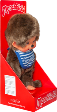 Monchhichi, urocza pluszowa małpka z brązowym futerkiem i niebieskim śliniakiem z logo, w czerwonym opakowaniu.