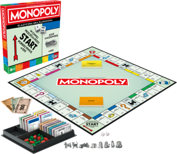 Gra planszowa Monopoly: na całego albo wcale! rozłożona z pudełkiem i akcesoriami na stole.