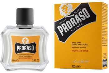 Balsam po goleniu Proraso Wood & Spice w butelce z żółtą etykietą i czarną nakrętką, obok żółte pudełko.
