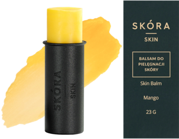 Otwarty balsam do skóry SKÓRA Mango w czarnym sztyfcie na tle żółtej smugi, obok zielonego pudełka z opisem.