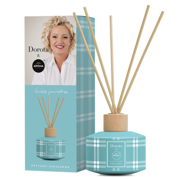 Błękitny odświeżacz powietrza Aroma Home & Dorota Świeże Powietrze w kratkę, z patyczkami, obok pudełko z Dorotą.