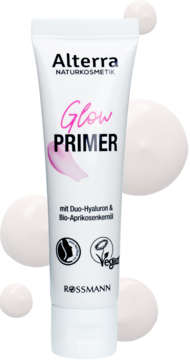 Biała tubka Alterra Glow Primer, baza rozświetlająca, widok z przodu, na tle z białymi kroplami produktu.
