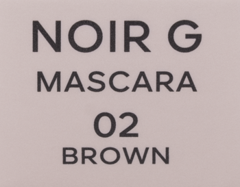 Zbliżenie na etykietę maskary Noir G od Guerlain, brązowy tusz do rzęs 02 BROWN, na jasnym tle.