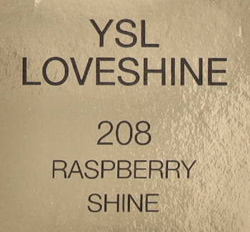 Złota etykieta YSL Loveshine, odcień 208 Raspberry Shine. Bliskie ujęcie etykiety produktu do ust.