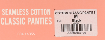 Seamless Cotton Classic Panties in black with a white label showing size M and barcode on a peach background.