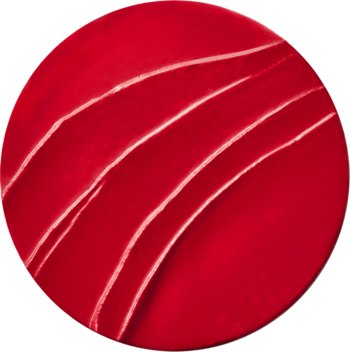 Zbliżenie na okrągłą, czerwoną teksturę matowej szminki Bourjois Rouge Edition Velvet z jasnymi smugami.